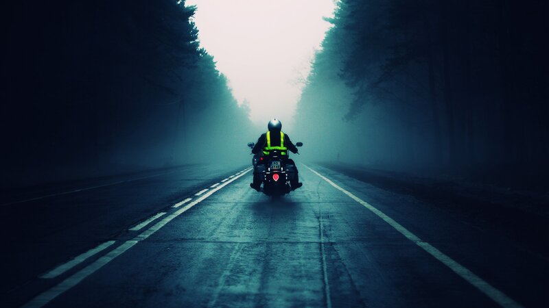 Motorcyclist on Foggy Road