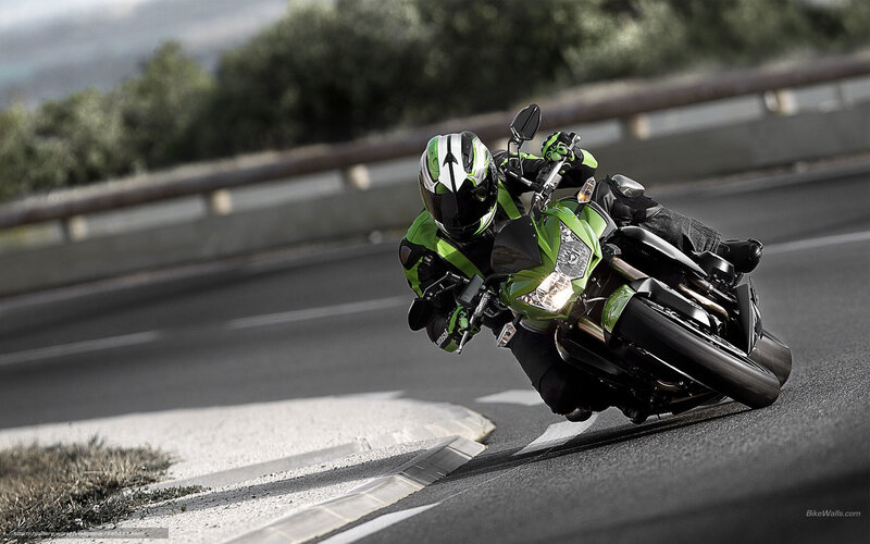 motorcyclist on green bike