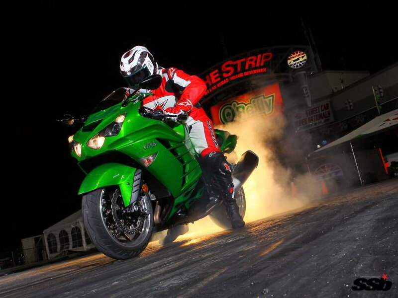 Motorcyclist on Green Bike — Dramatic, Night