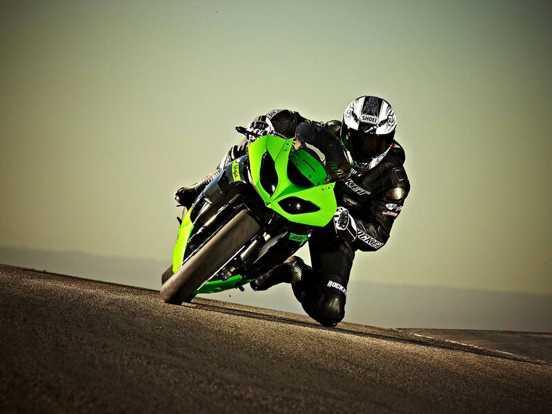 Motorcyclist on Green Bike — Dramatic