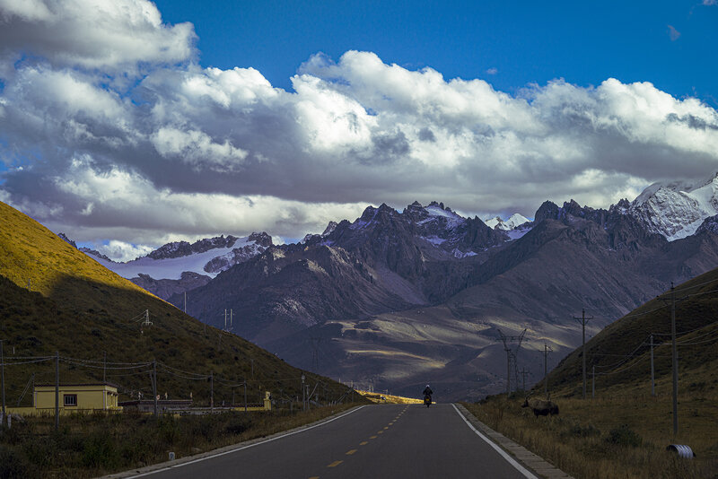 Motorcyclist on Mountain Road — Blue, Dramatic, Afternoon