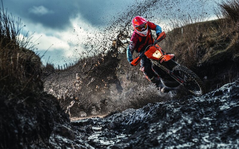Motorcyclist on Muddy Trail
