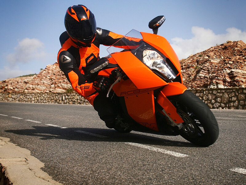 Motorcyclist on orange bike