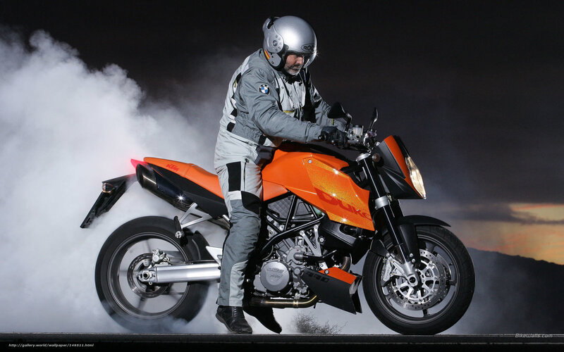 Motorcyclist on Orange Bike — Dramatic