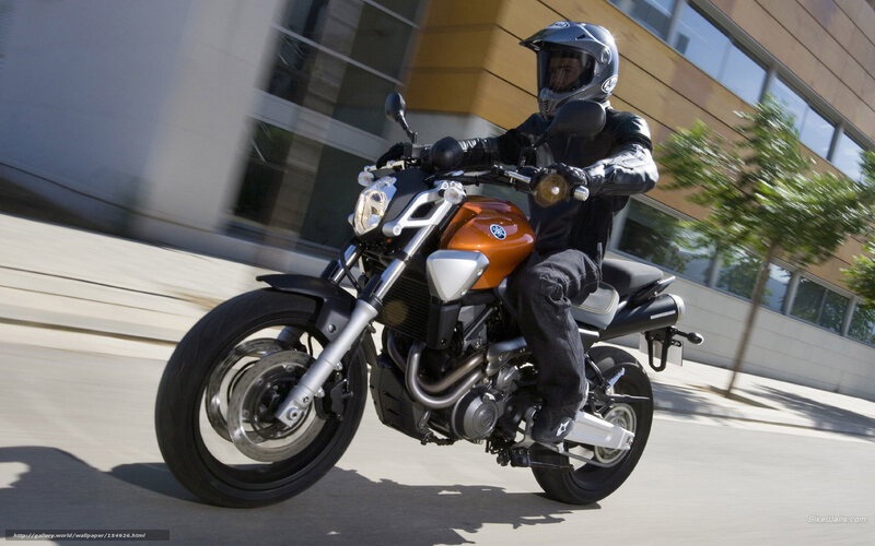 Motorcyclist on Orange Bike — Dynamic, Afternoon, Photograph, Building