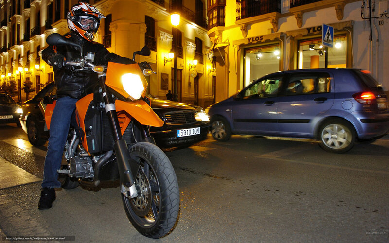 Motorcyclist on Orange Bike — Urban