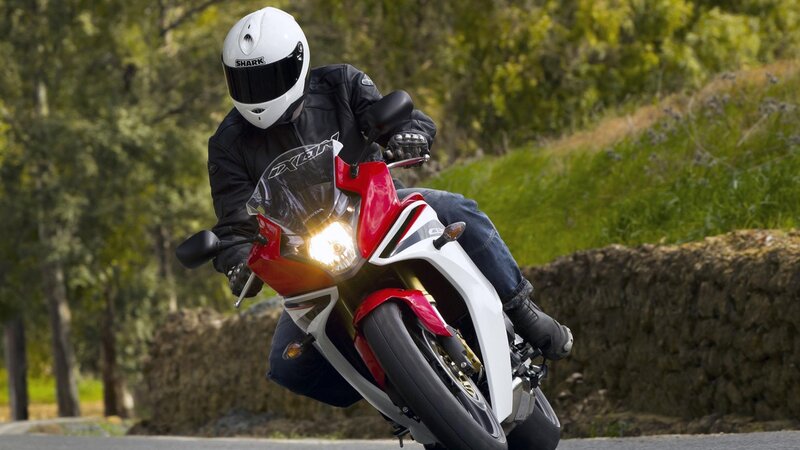 Motorcyclist on Red Bike — Dynamic, Afternoon, Photograph, Helmet, Jacket, Trees