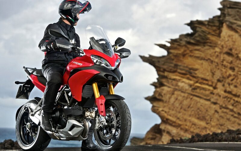 Motorcyclist on Red Motorcycle — Dramatic
