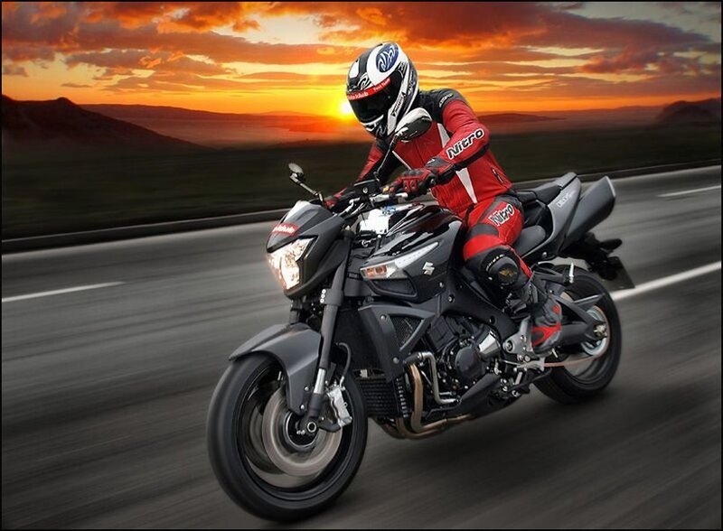 Motorcyclist on road at sunset
