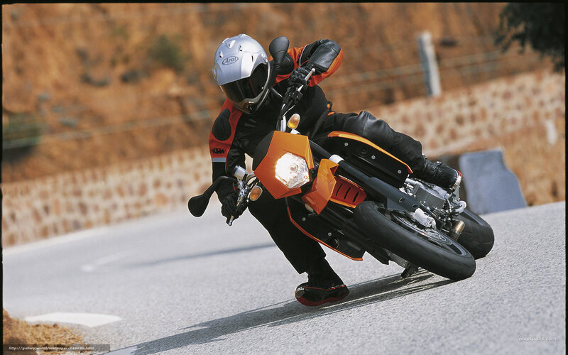 Motorcyclist on Road — Orange, Dynamic, Afternoon, Photograph, Helmet, Stone Wall