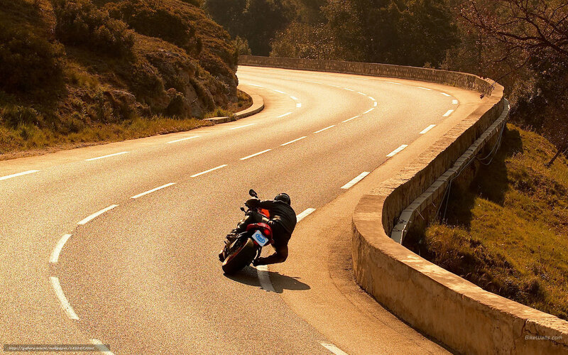 Motorcyclist on Winding Road — Brown
