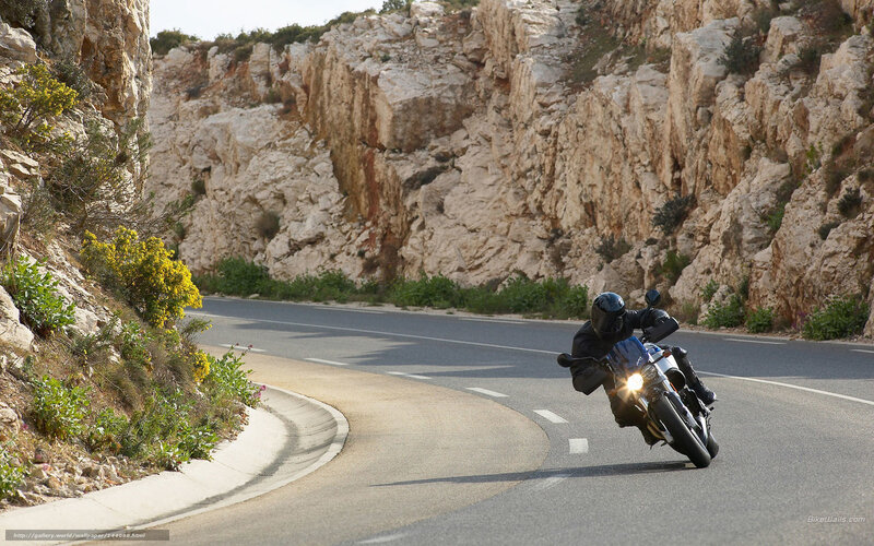Motorcyclist on Winding Road — Gray, Dynamic, Afternoon, Photograph, Cliffs