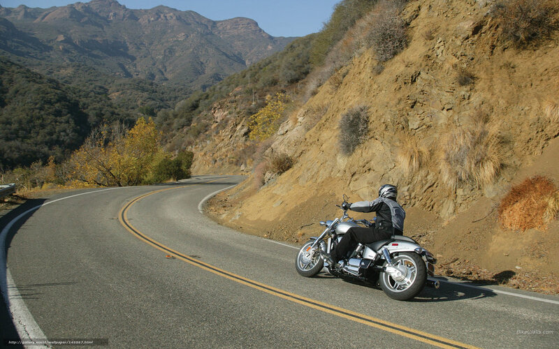 Motorcyclist on Winding Road — Gray, Serene