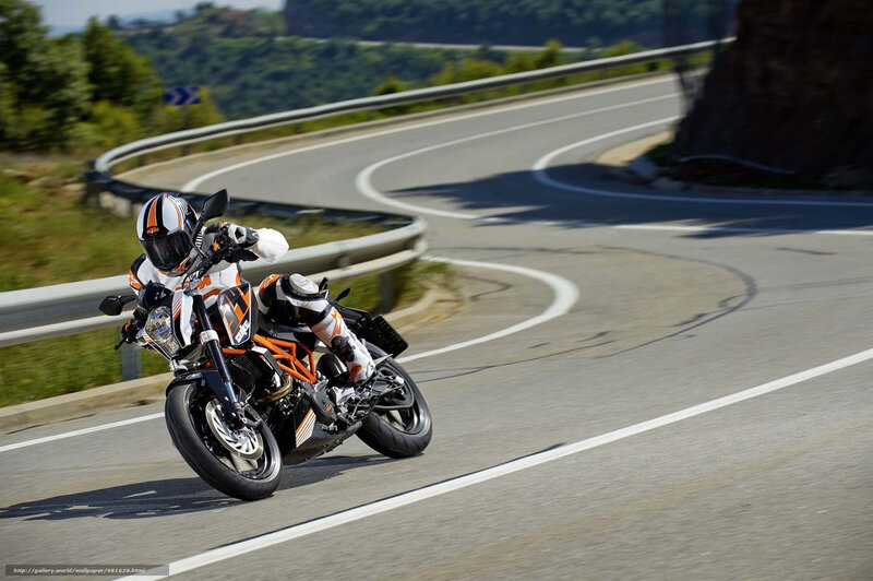Motorcyclist on Winding Road — Orange, Dynamic, Afternoon, Photograph, Guardrail