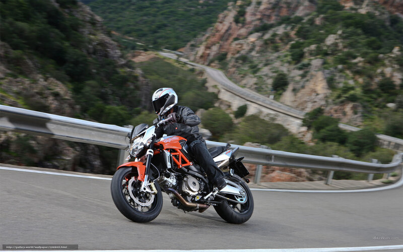 Motorcyclist on Winding Road — Orange, Dynamic, Afternoon, Photograph, Mountain