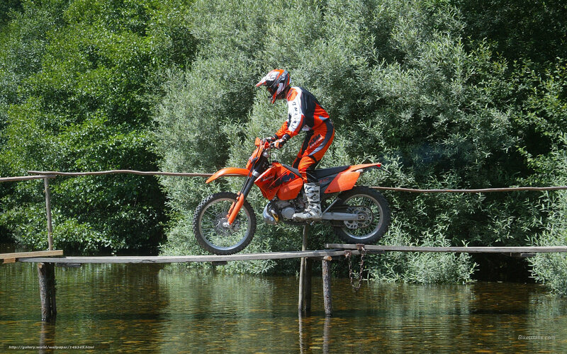 Motorcyclist on wooden bridge
