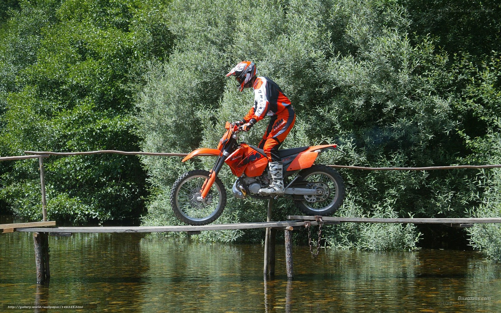 Motorcyclist on wooden bridge