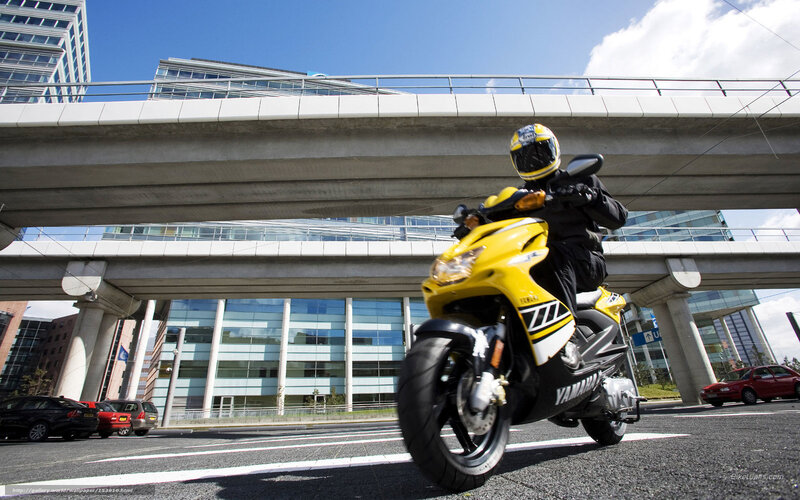 Motorcyclist on Yellow Scooter