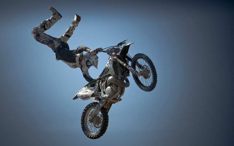 Motorcyclist Performing Stunt — Blue, Dramatic