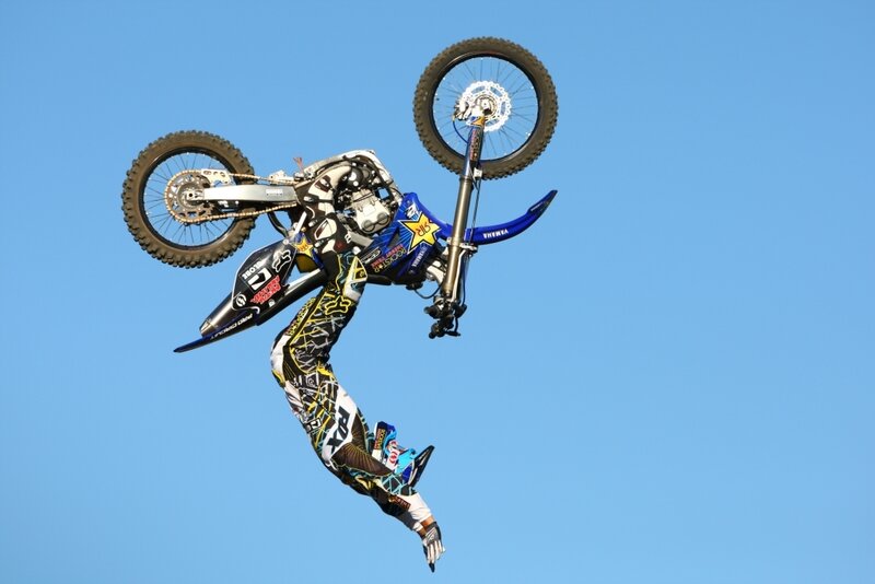 Motorcyclist Performing Stunt — Blue