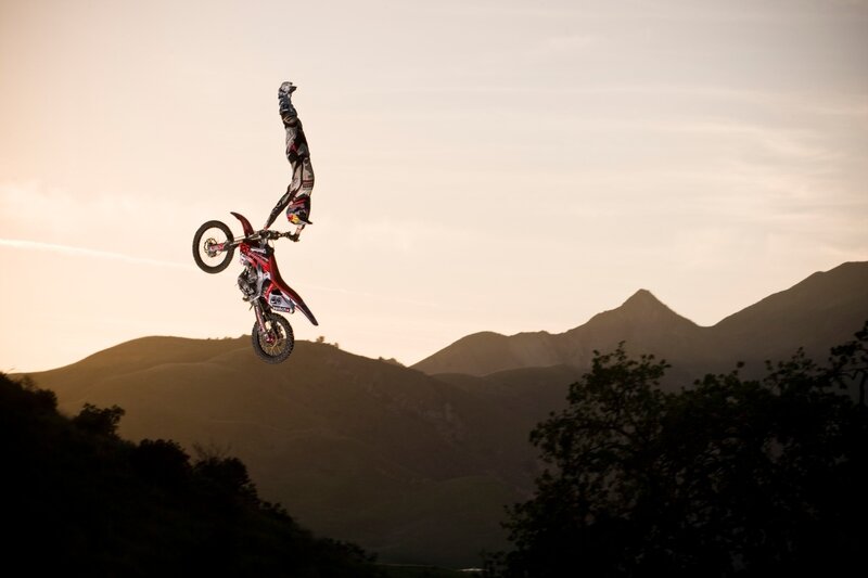 Motorcyclist Performing Stunt — Orange, Dramatic