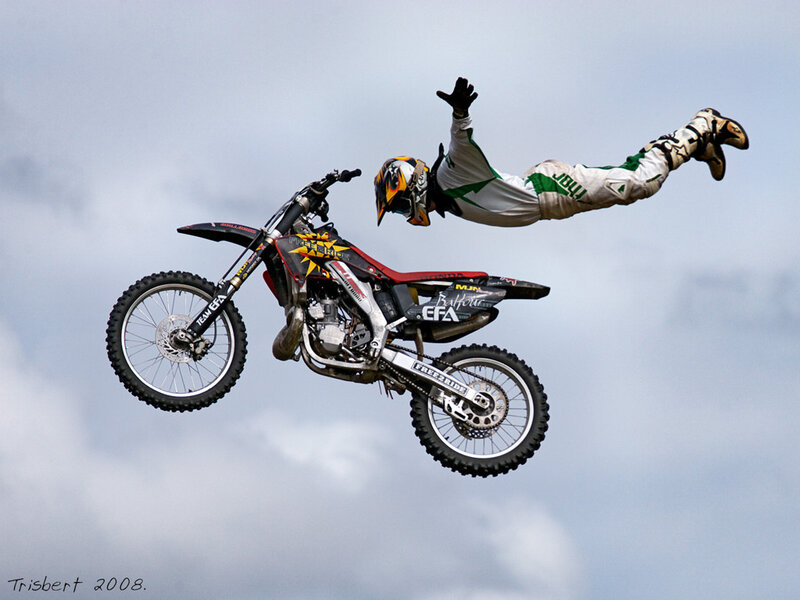 Motorcyclist Performing Stunt — White