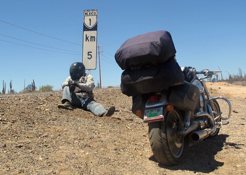 Motorcyclist Resting on Roadside