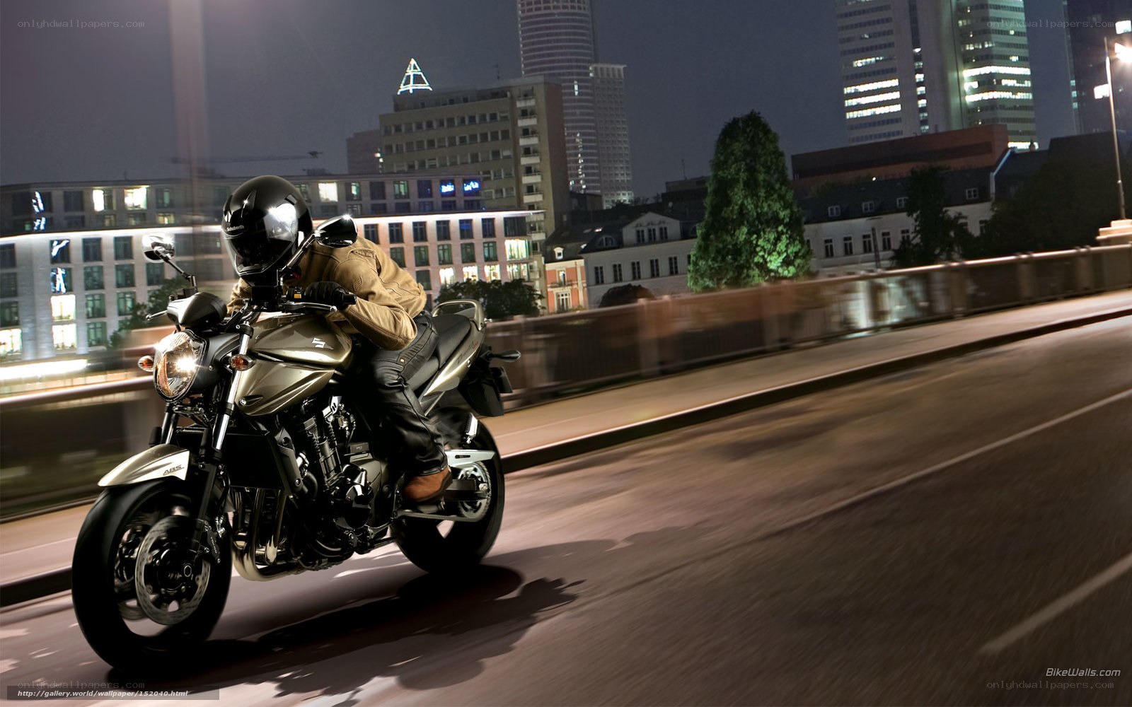 Motorcyclist riding at night in city