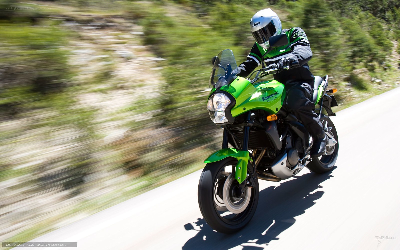 motorcyclist riding green bike