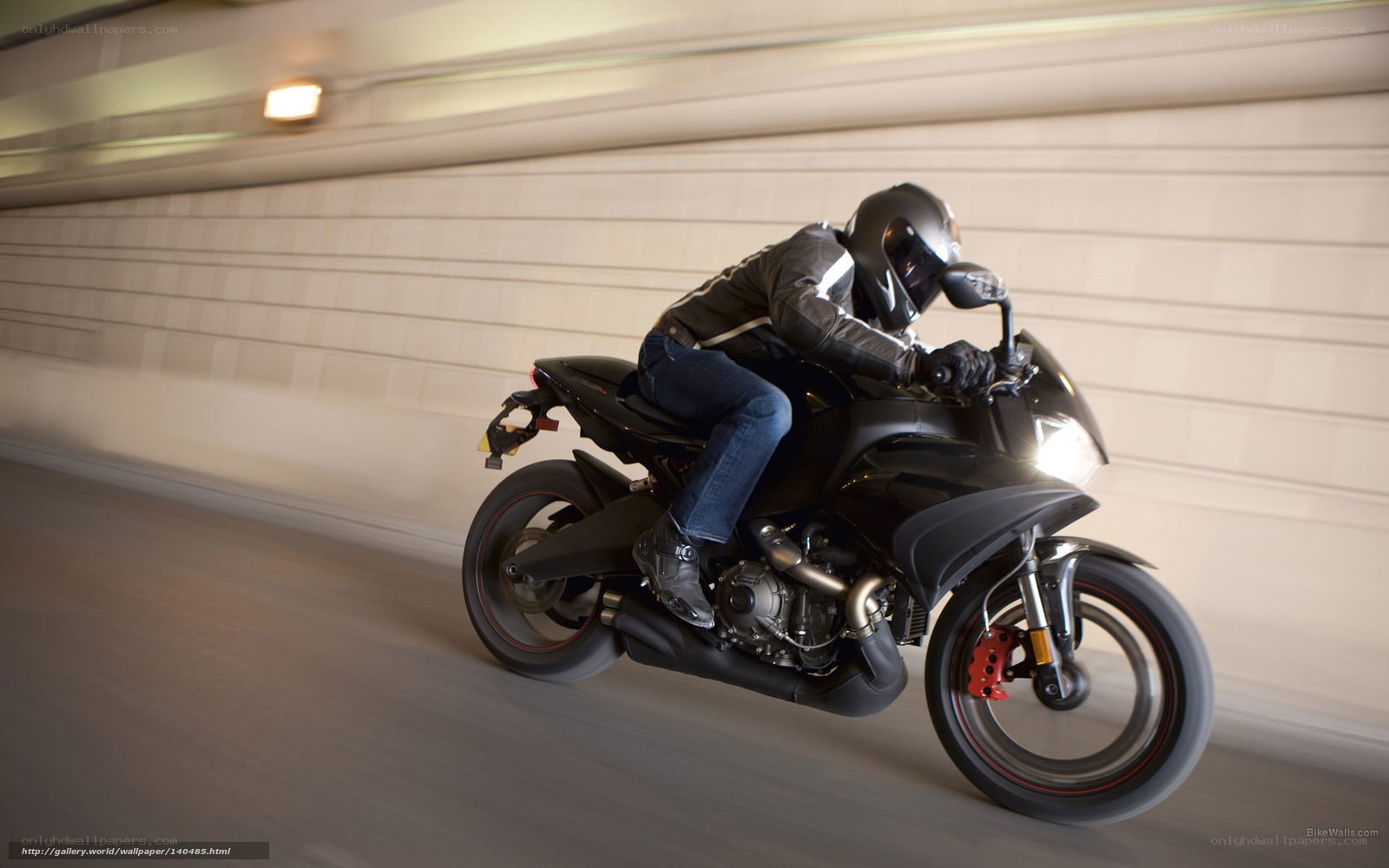 motorcyclist riding in tunnel