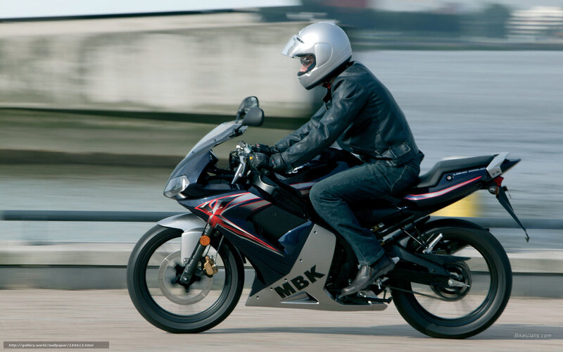 motorcyclist riding on a bridge