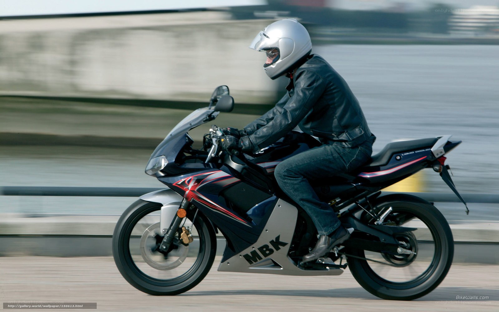 motorcyclist riding on a bridge