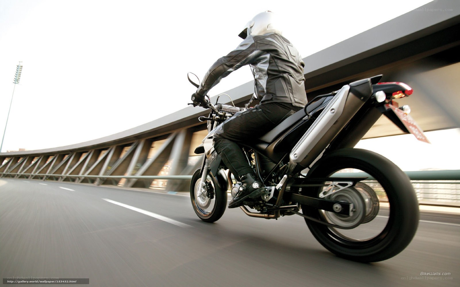 motorcyclist riding on a bridge