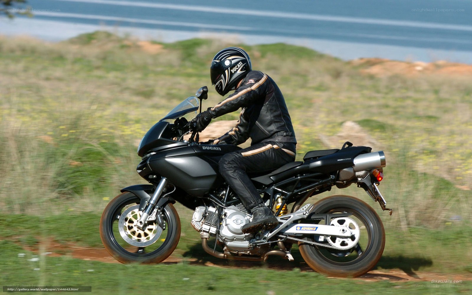 Motorcyclist riding on a coastal path