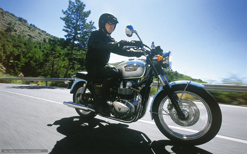 Motorcyclist riding on a sunny road