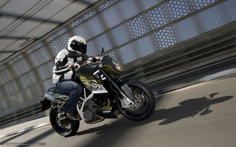 motorcyclist riding on bridge