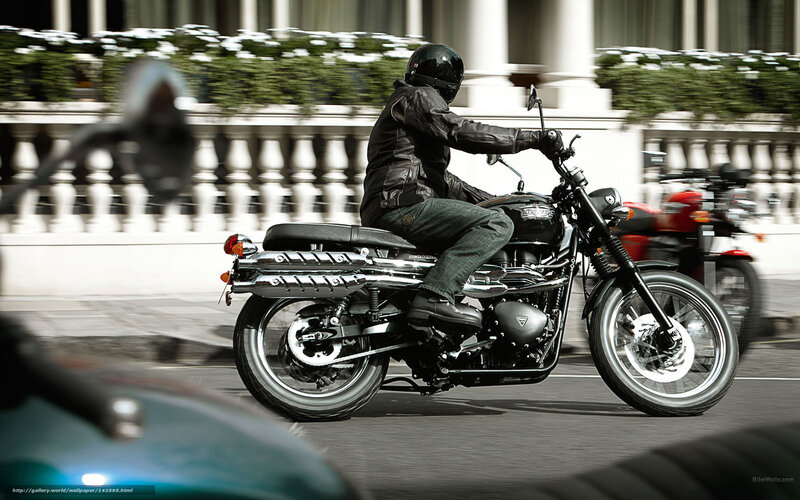 Motorcyclist riding on city street