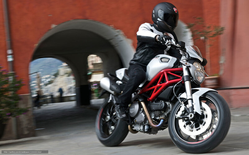 Motorcyclist riding through archway