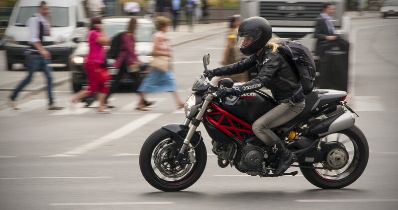 Motorcyclist riding through city street