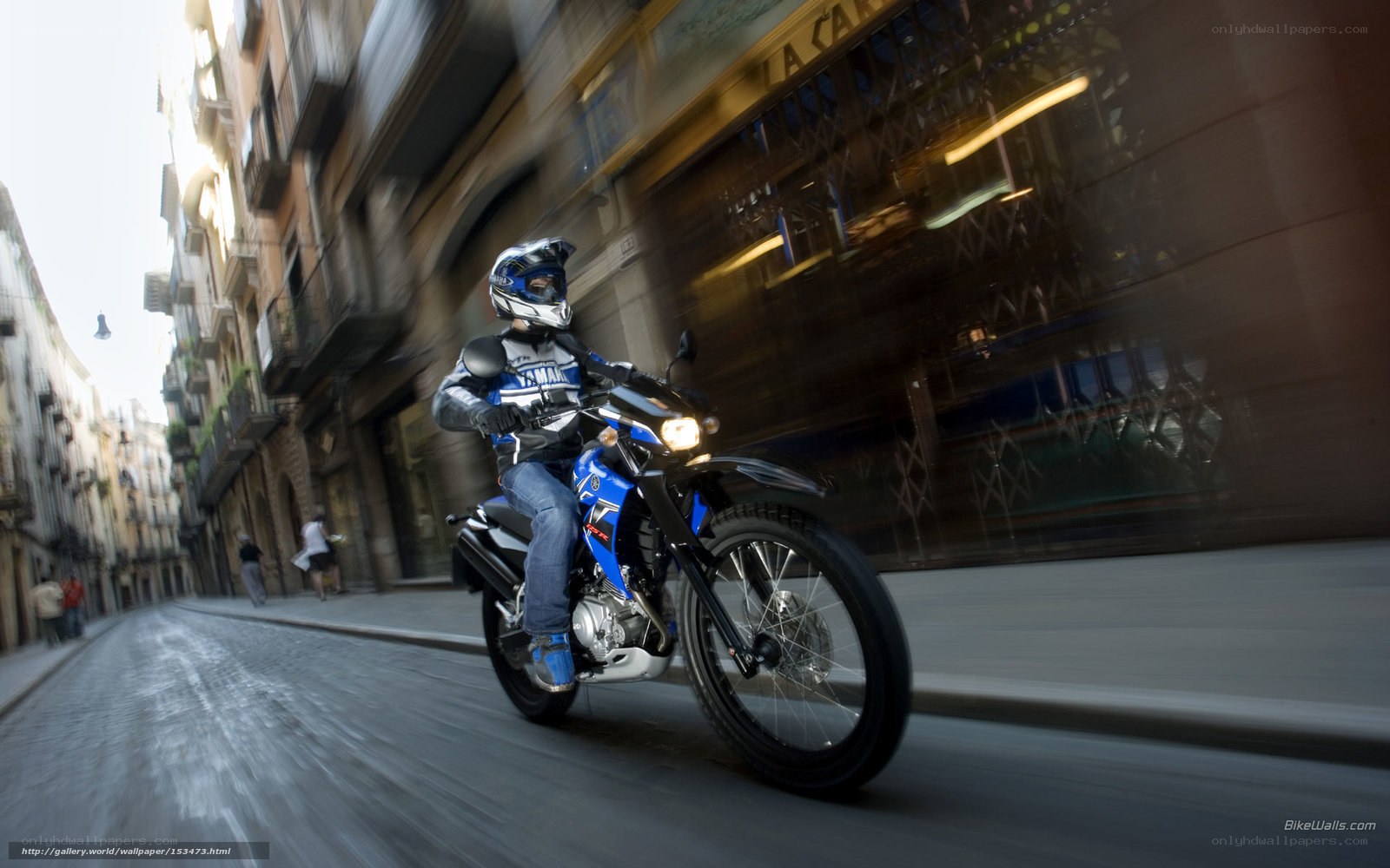 Motorcyclist riding through city street