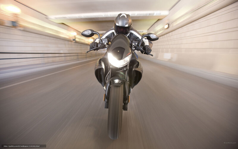 Motorcyclist riding through tunnel