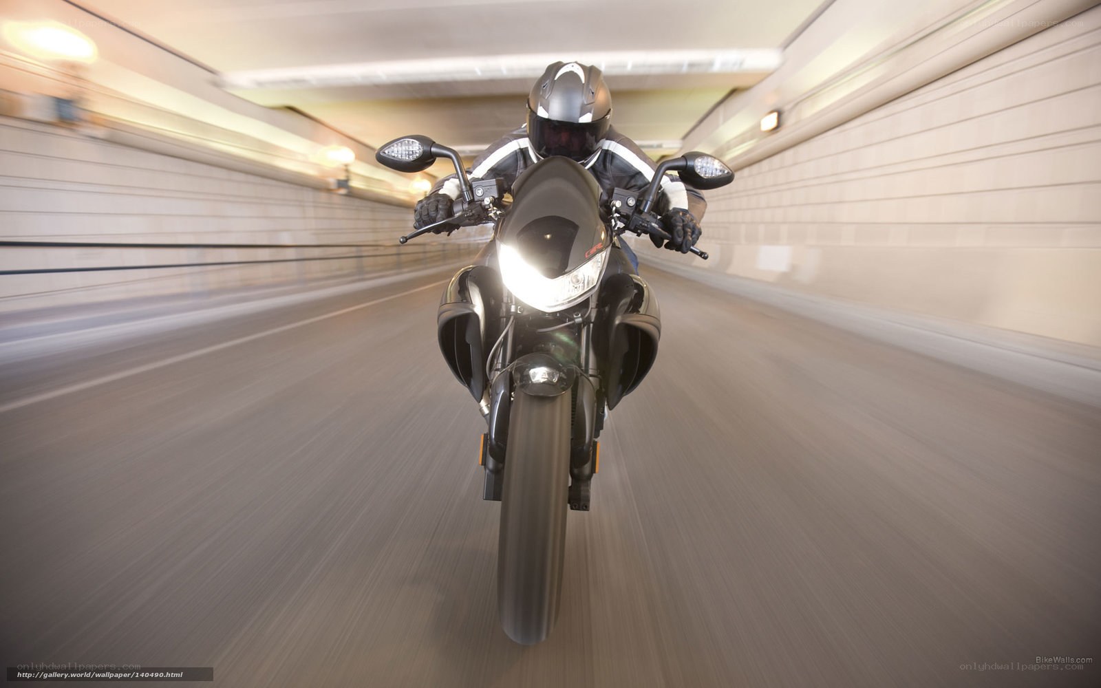Motorcyclist riding through tunnel