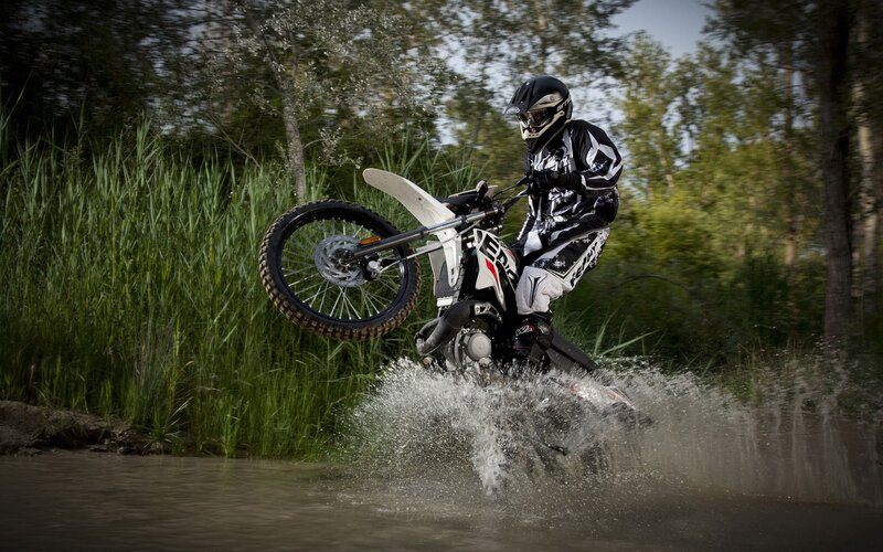 motorcyclist riding through water