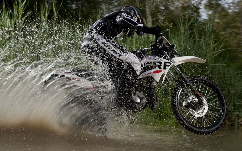 Motorcyclist riding through water