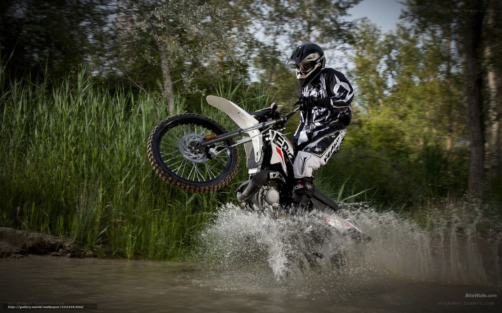motorcyclist riding through water