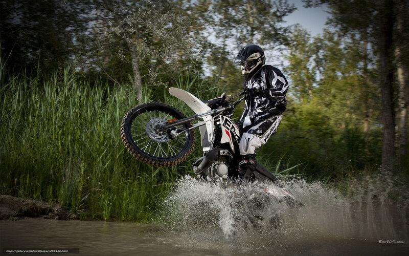 motorcyclist riding through water