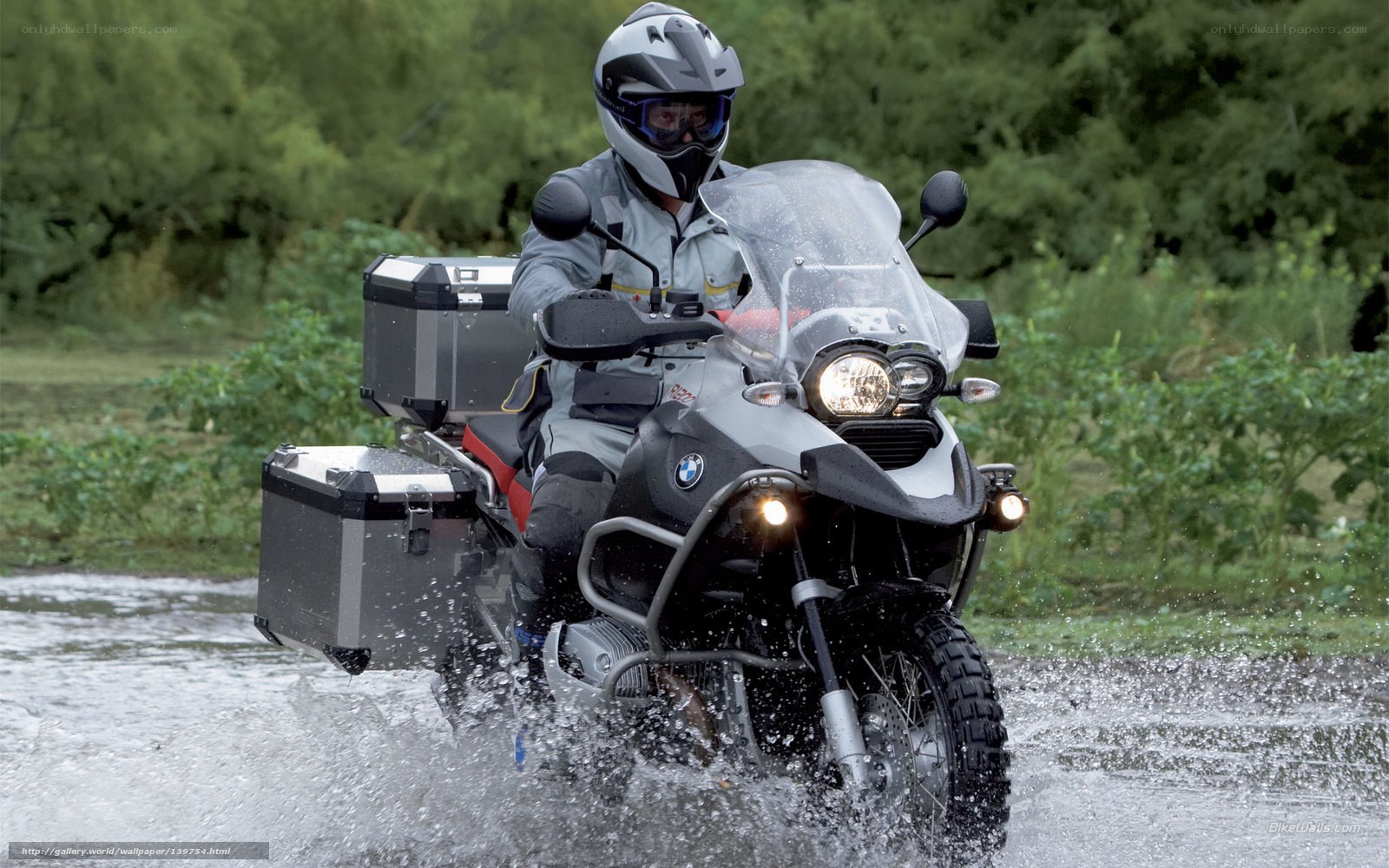 Motorcyclist riding through water