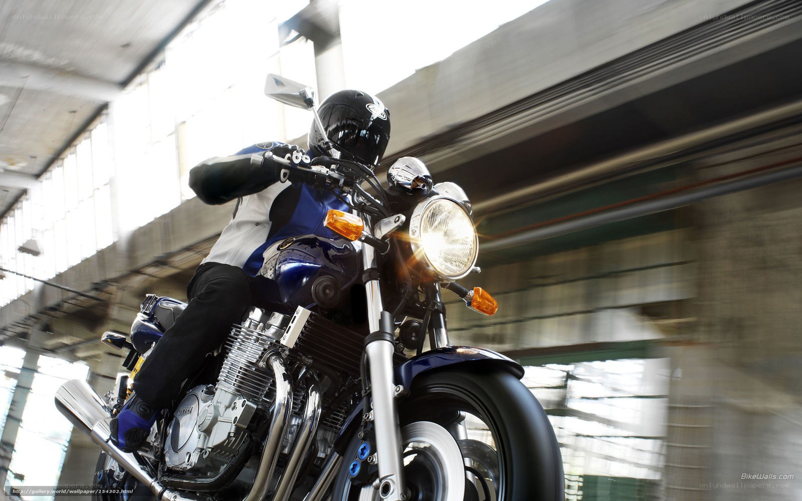Motorcyclist riding under overpass