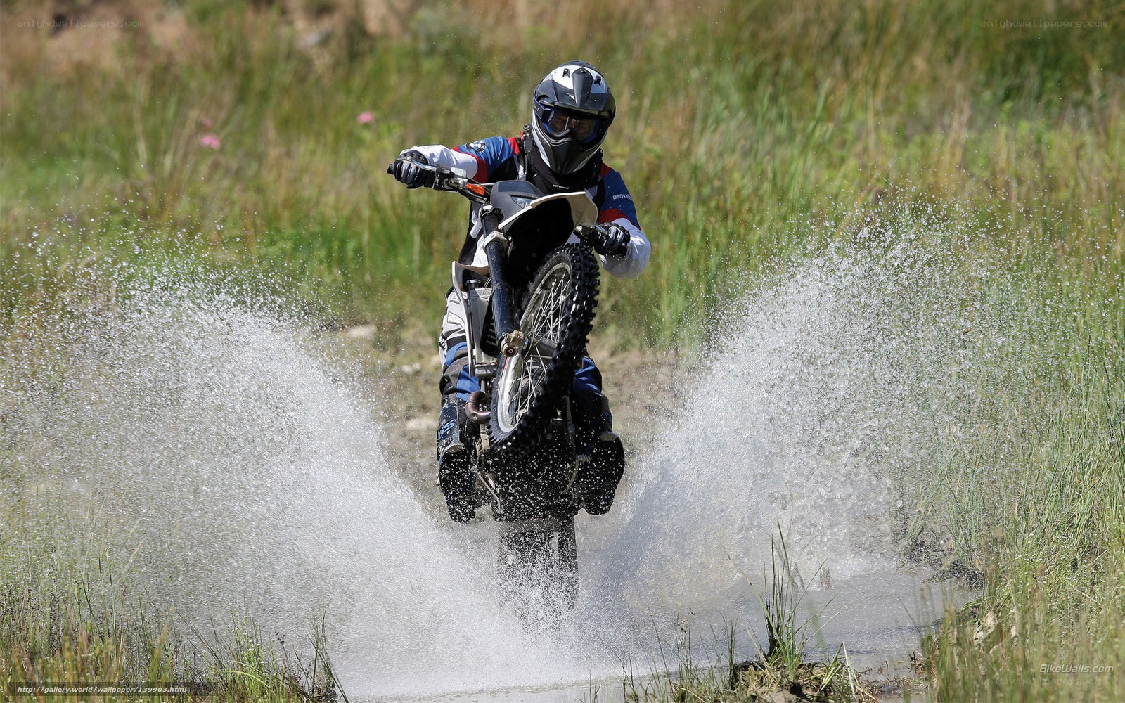 Motorcyclist splashing through water