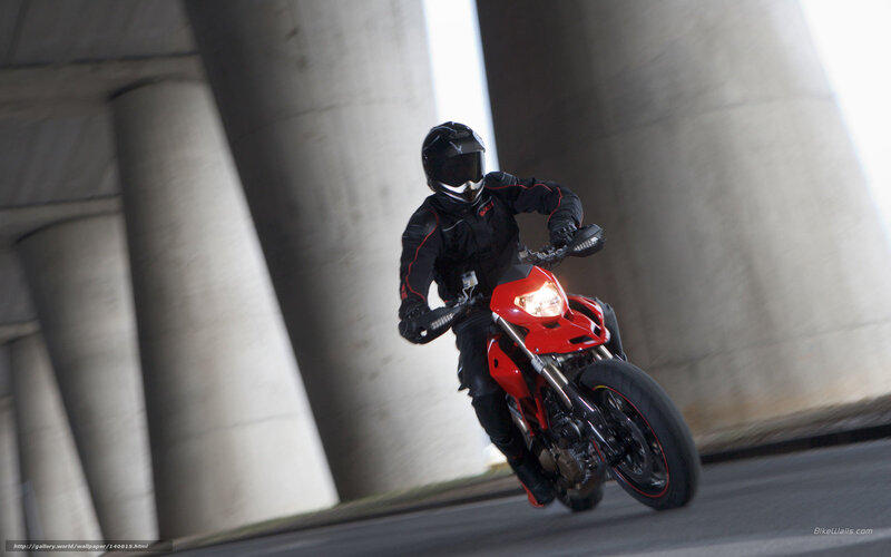 Motorcyclist under a bridge